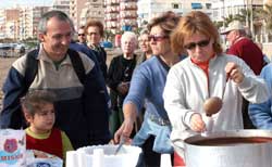 In the centre, the president of ADIA, receives a cup of chocolate